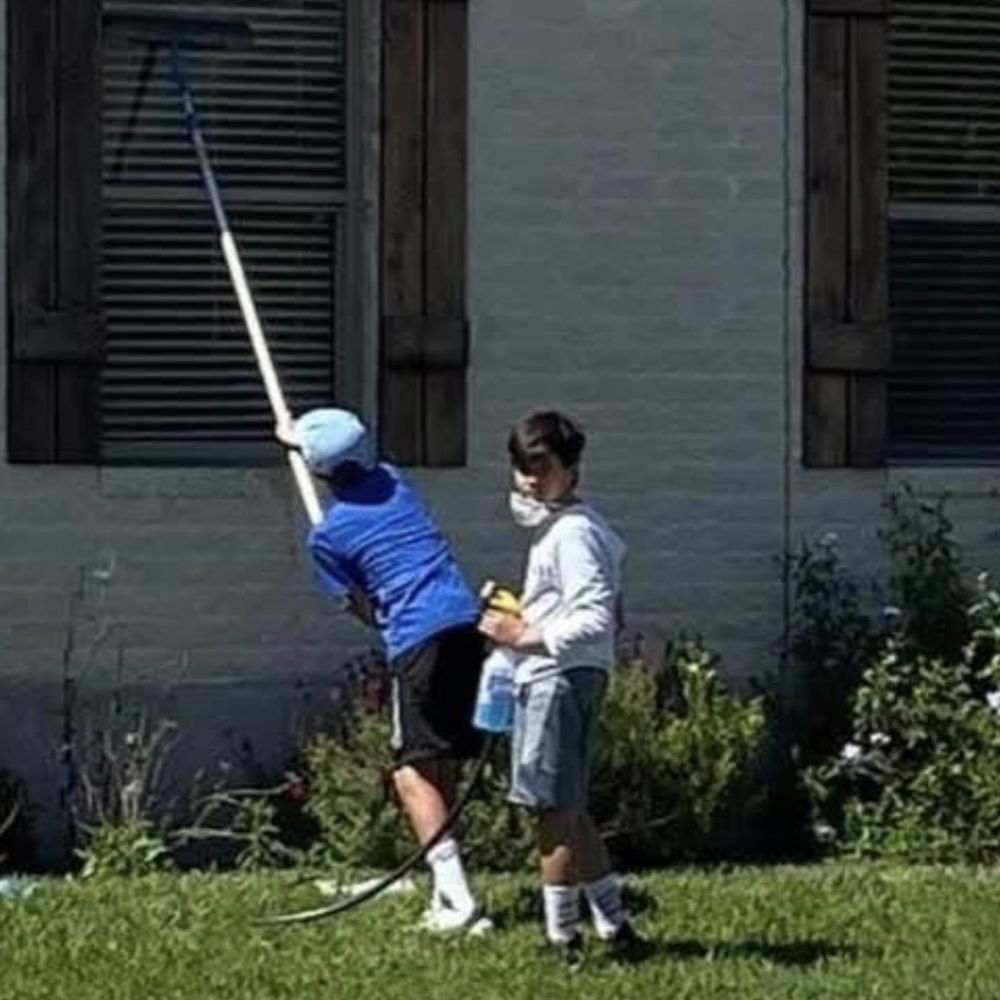 Andrei at age 11 cleaning windows with a friend, the start of A's Exterior Services