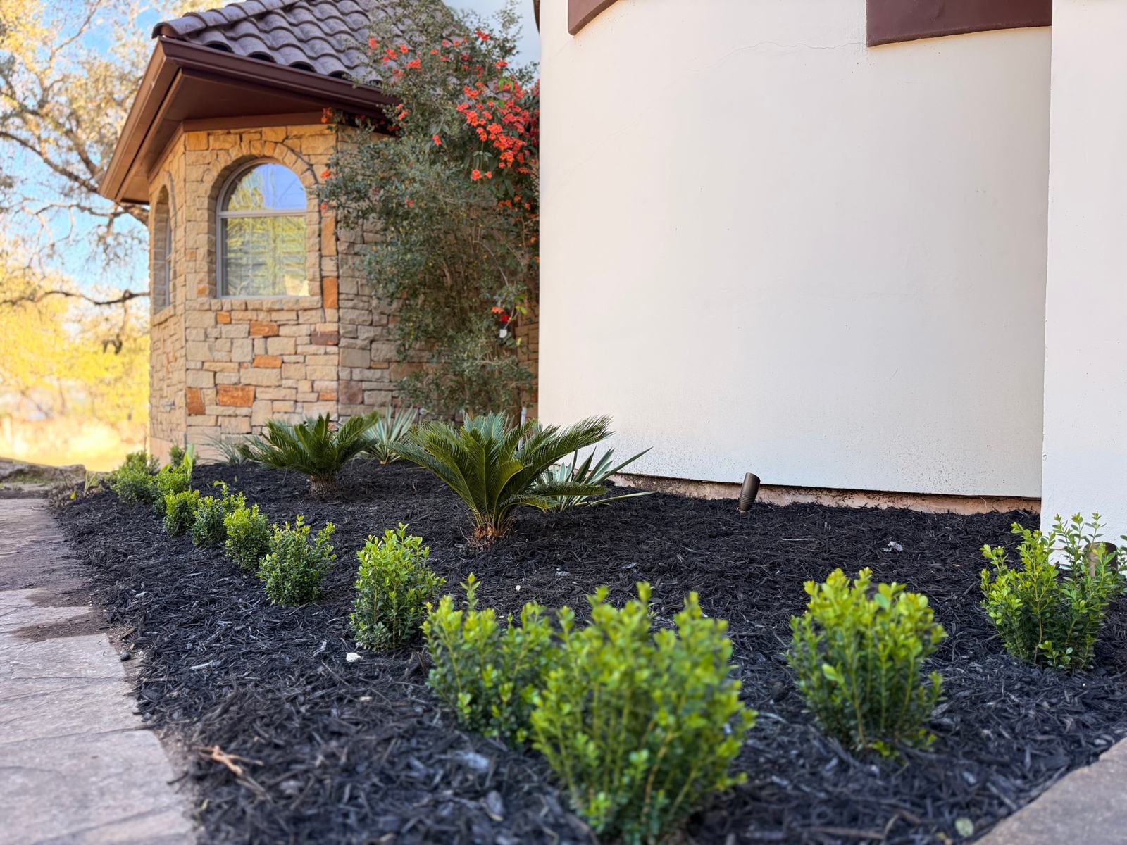 New planting bed with fresh mulch and landscape lighting